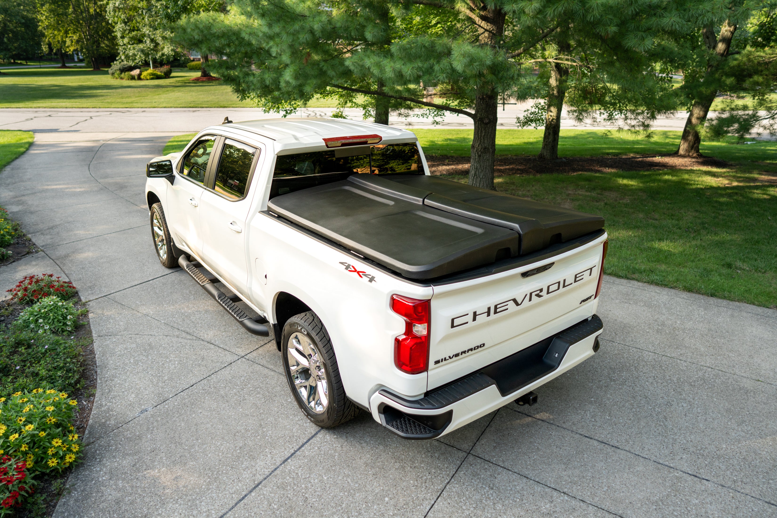 White Chevrolet Silverado with a closed FastBack truck bed cover