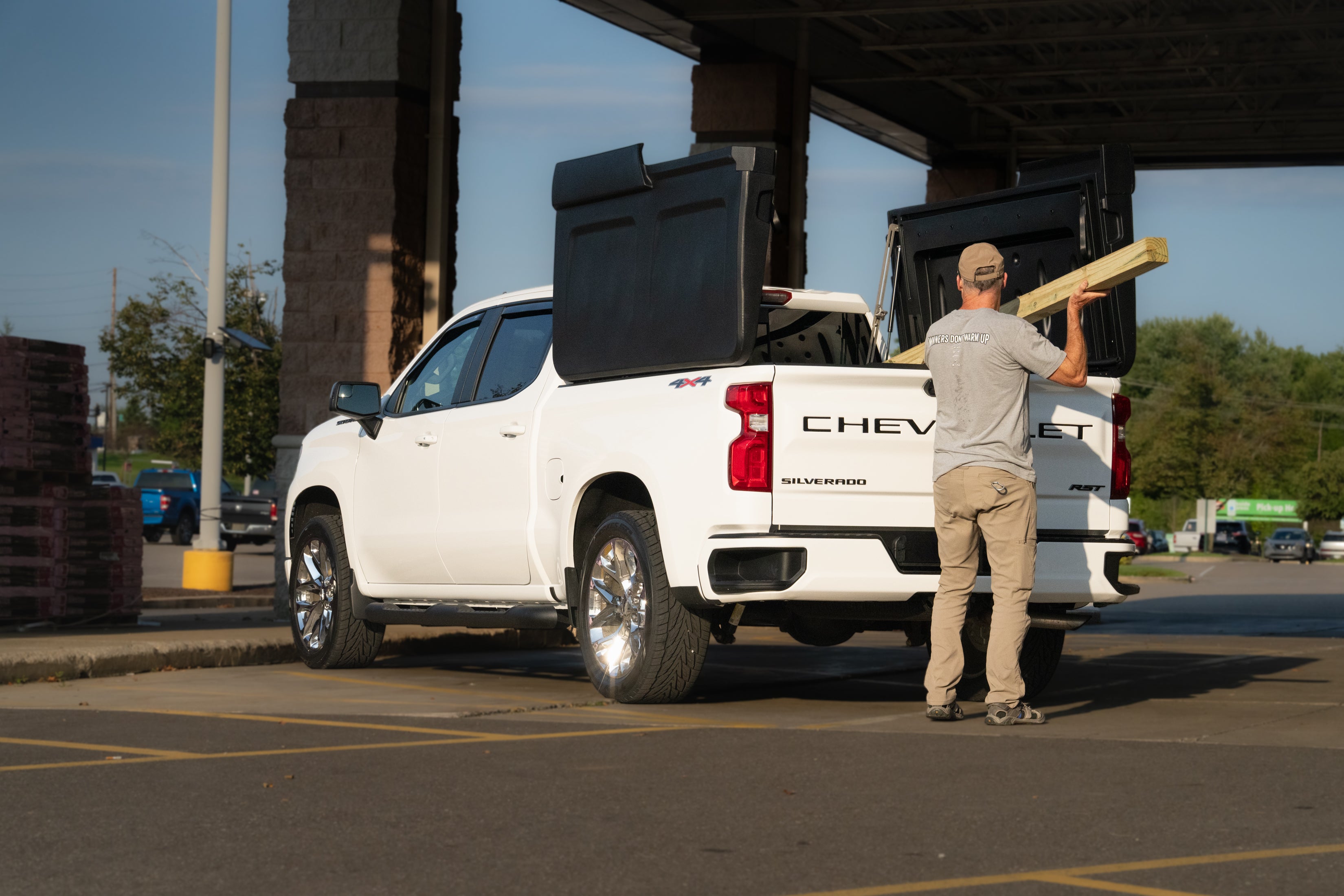 Loading lumber into a truck with FastBack cover panels open